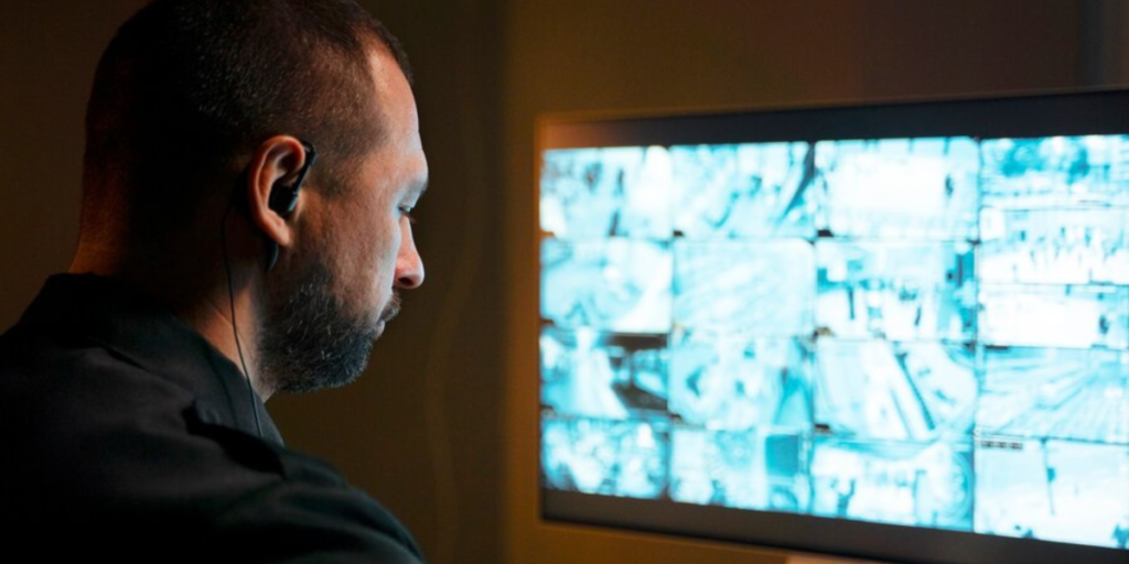 A man watching a security monitor.